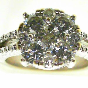 Estate Diamond Dinner Ring - Women's 
14 Karat White Estate Dinner Ring 
Finger Size 5.75 Gram Weight 5.2 
1 Center Diamond; 0.10ct Shape: Round; Clarity: I1; Colour: I With 4 Round Diamonds 0.33 ctw and 4 Round Diamonds 0.04 ctw and 20 Round Diamonds