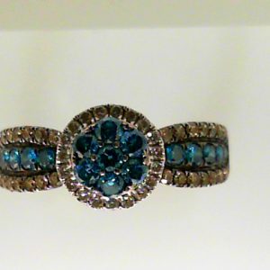 Estate Diamond Dinner Ring - Women's 
14 Karat White Estate Dinner Ring 
Finger Size 7.25 Gram Weight 4.5 
7 Center Diamonds Shape: Round; Clarity: VS2 With 20 Round Diamonds 0.20 ctw and 12 Round Diamonds 0.34 ctw and 32 Round Diamonds 0.30 ctw 1.11