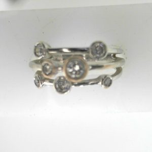 Estate Diamond Dinner Ring - Women's 
18 Karat White Estate Dinner Ring 
Finger Size 6.75 Gram Weight 4.8 
7 Center Diamonds Shape: Round; Clarity: SI; Colour: H 0.5