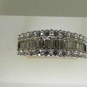 Estate Diamond Dinner Ring - Women's 
14 Karat White Estate Dinner Ring Width 7mm 
Finger Size 9 Gram Weight 3.5 
18 Center Diamonds Shape: Baguette; Clarity: VS; Colour: G/H With 22 Round Diamonds 1.70 ctw 2.6