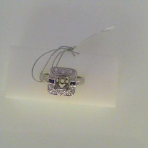 Diamond Semi-Mount Ring 
14 Karat White Ring 
Finger Size 6.5 
4 Center Sapphires Shape: Princess; Colour: Blue With 12 Round Diamonds 0.22 ctw 0.32