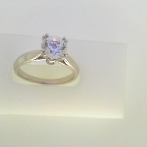 Diamond Semi-Mount Ring 
14 Karat White Ring 
Finger Size 6.25 
1 Center Cubic Zirconium 1.00ct Shape: Round Round Diamond 0.03 ctw 1.03