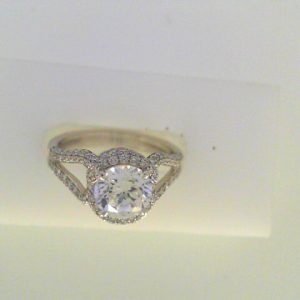 Diamond Semi-Mount Ring 
18 Karat White Ring 
Finger Size 7 
 Center Diamond Shape: Round; Clarity: VS1; Colour: F/G 0.58