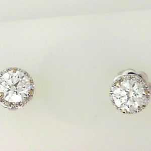 Estate Diamond Earrings 
18 Karat White Estate Diamond Earrings 
Gram Weight 2.19 
2 Center Diamonds Shape: Round; Clarity: I1; Colour: E With 20 Round Diamonds 1.03