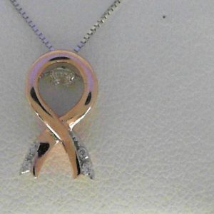 Diamond Pendant/Necklace 
14 Karat Rosé Diamond Pendant 
 Chain Style: Box 14 Karat White Length: 18in 
1 Center Diamond 0.08ct Shape: Round With 2 Round Diamonds 0.013 ctw and 2 Round Diamonds 0.01 ctw 0.103