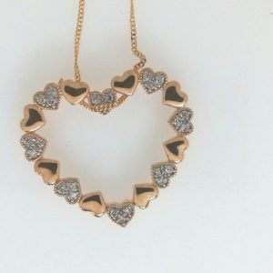 Estate Diamond Heart Pendant/Necklace 
10 Karat Yellow Estate Diamond Pendant 
Gram Weight 3.6 Chain Style: Curb 10 Karat Yellow 17 
24 Center Diamonds Shape: Round