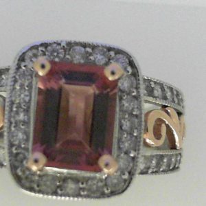 Tourmaline Ring 
14 Karat Rose/White Pink Tourmaline Ring With Finger Size 5.75 
Width 3.59mm Gram Weight 6.09 
1 Center Tourmaline Shape: Emerald; Colour: Pink With 40 Round Diamonds 0.50 ctw