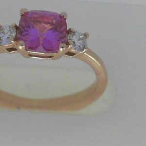 Sapphire Ring 
14 Karat Rosé Pink Sapphire Ring With Finger Size 5.25 
Width 1.88mm Gram Weight 2.72 
1 Center Sapphire 0.88ct Shape: Cushion; Colour: Pink With 2 Round Diamonds 0.16 ctw