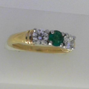 Emerald Ring
18 Karat Yellow/White Emerald Ring With Finger Size 6
Width 2.07mm Gram Weight 4.53
1 Center Emerald 0.23ct Shape: Round With 2 Round Diamonds 0.46 ctw