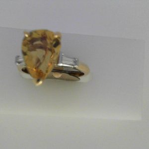 Emerald Ring
14 Karat Yellow/White Orangy Yellow Emerald Ring With Finger Size 6
Width 1.89mm Gram Weight 3.33
1 Center Emerald 3.00ct Shape: Pear; Colour: Orangy Yellow With 2 Baguette Diamonds 0.26 ctw