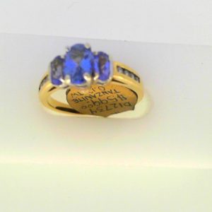 Tanzanites Ring 
14 Karat Yellow/White Tanzanites Ring With Finger Size 6.75 
Width 2.05mm Gram Weight 3.26 
3 Center Tanzanites Shape: Oval With 8 Round Diamonds 0.12 ctw