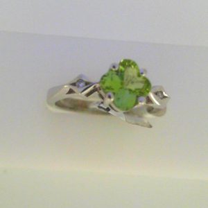 Peridot Ring 
14 Karat White Peridot Ring With Finger Size 6.25 
Width 2.7mm Gram Weight 3.6 
1 Center Peridot Shape: Fantasy Cut With 2 Round Diamonds