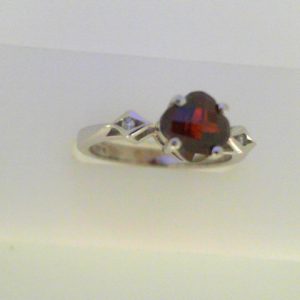 Garnet Ring 
14 Karat White Garnet Ring With Finger Size 6.25 
Width 2.6mm Gram Weight 3.5 
1 Center Garnet Shape: Fantasy Cut With 2 Round Diamonds
