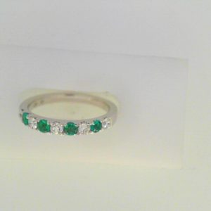 Diamonds Ring 
18 Karat White Diamonds Ring With Finger Size 6.5 
 
6 Center Diamonds Shape: Round With 4 Round Emeralds 0.25 ctw