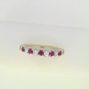 Diamonds Ring 
18 Karat White Diamonds Ring With Finger Size 6.5 
 Gram Weight 3.72 
6 Center Diamonds Shape: Round With 7 Round Rubies 0.38 ctw