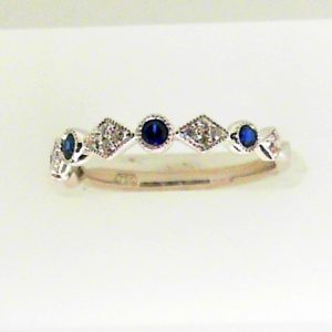Sapphires Ring 
18 Karat White Sapphires Ring With Finger Size 5.5 
 
4 Center Sapphires Shape: Round With 14 Round Diamonds 0.09 ctw