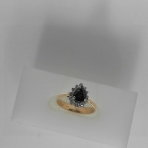 Sapphire Ring 
14 Karat Yellow/White Blue Sapphire Ring With Finger Size 6 
 Gram Weight 2.26 
1 Center Sapphire 0.66ct Shape: Pear; Colour: Blue With 12 Round Diamonds 0.09 ctw