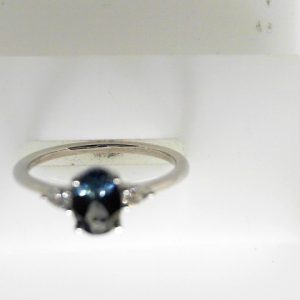 Sapphire Ring 
14 Karat White Bluish Green Sapphire Ring With Finger Size 6.75 
 
1 Center Sapphire 0.95ct Shape: Oval; Colour: Bluish Green With 2 Oval Diamonds 0.11 ctw