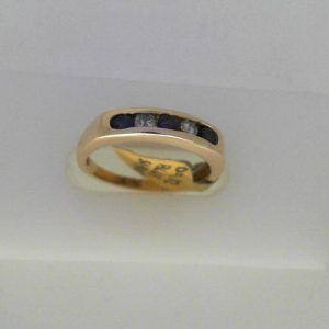 Sapphires Estate Ring 
14 Karat Yellow Sapphires Ring With Finger Size 6.25 
Width 2.15mm Gram Weight 2.72 
3 Center Sapphires Shape: Round With 2 Round Diamonds 0.12 ctw