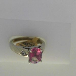 Topaz Estate Ring 
14 Karat White Pink Topaz Ring With Finger Size 7 
Width 2.47mm Gram Weight 4.74 
1 Center Topaz Shape: Oval; Colour: Pink With 2 Round Diamonds 0.08 ctw