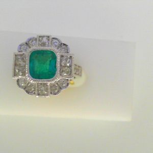 Emerald Estate Ring 
18 Karat White Emerald Ring With Finger Size 7.5 
Width 15mm Gram Weight 7.1 
1 Center Emerald 1.10ct Shape: Fantasy Cut With 22 Round Diamonds 1.74 ctw