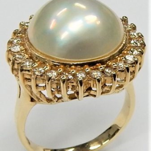 Pearl Estate Ring E13332
14 Karat Yellow White Pearl Ring With Finger Size 8 
Width 15mm Gram Weight 9.7 
1 Center Pearl Shape: Mabe'; Colour: White Round Diamond 0.50 ctw