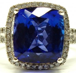 Tanzanite Estate Ring 
18 Karat White Blue Tanzanite Ring With Finger Size 7 
 Gram Weight 8.2 
1 Center Tanzanite 7.50ct Shape: Cushion; Clarity: VVS; Colour: Blue With 60 Round Diamonds 0.30 ctw