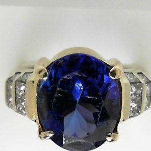 Tanzanite Estate Ring 
18 Karat Yellow/White Tanzanite Ring With Finger Size 7 
 Gram Weight 11.3 
1 Center Tanzanite 7.05ct Shape: Oval With 16 Various Shapes Diamonds 1.00 ctw