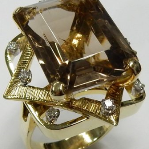 Smokey Quartz Estate Ring 
14 Karat Yellow Smokey Quartz Ring With Finger Size 8.25 
 Gram Weight 13.25 
1 Center Smokey Quartz 21.00ct Shape: Emerald With 8 Round Diamonds 0.20 ctw