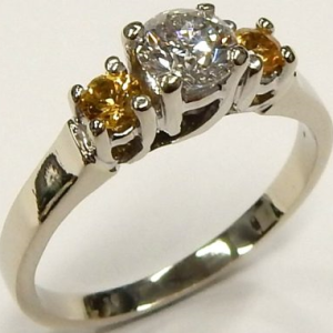 Diamond Estate Ring 
14 Karat White H Diamond Ring With Finger Size 5 
 Gram Weight 2.6 
1 Center Diamond 0.38ct Shape: Round; Clarity: SI2; Colour: H With 2 Round Sapphires