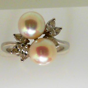 Pearls Estate Ring 
18 Karat White Pearls Ring With Finger Size 7 
 Gram Weight 4.8 
2 Center Pearls Shape: Round With 6 Marquise Diamonds