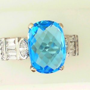 Topaz Estate Ring 
14 Karat White Blue Topaz Ring With Finger Size 10 
 Gram Weight 7.51 
1 Center Topaz 6.60ct Shape: Cushion; Colour: Blue With 18 Various Shapes Diamonds 0.50 ctw