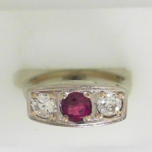 Ruby Estate Ring 
18 Karat White Ruby Ring With Finger Size 5.75 
 Gram Weight 4.4 
1 Center Ruby 0.39ct Shape: Round With 2 EURO Cut Diamonds 0.50 ctw