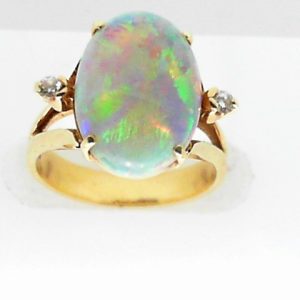 Opal Estate Ring 
14 Karat Yellow Opal Ring With Finger Size 4.75 
 Gram Weight 4.2 
1 Center Opal 3.00ct Shape: Oval With 2 Round Diamonds 0.06 ctw