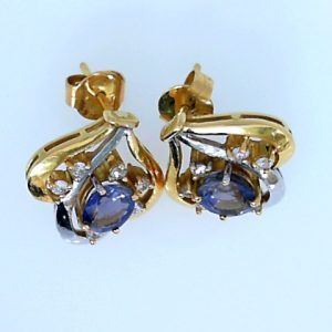 Estate Earrings With Tanzanites 
18 Karat Yellow/White Tanzanites Earrings 
 Gram Weight 7.78 
2 Center Tanzanites Shape: Oval With 12 Round Diamonds 0.36 ctw