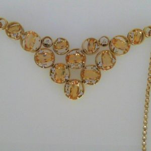 Citrines Pendant 
18 Karat Yellow Citrines Pendant 
Gram Weight 18.18 Chain Style: Cable Link 18 Karat Yellow Length: 17in 
12 Center Citrines Shape: Oval With 28 Round Diamonds 0.25 ctw