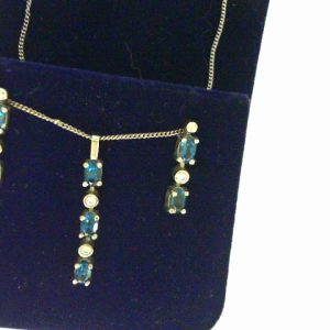 Precious Topazes Pendant 
14 Karat White Blue Precious Topazes Pendant 
 Chain Style: Curb 14 Karat White Length: 18in 
3 Center Precious Topazes Shape: Oval; Colour: Blue With 2 Round Diamonds 0.05 ctw