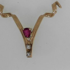 Ruby Estate Pendant 
14 Karat Yellow Ruby Pendant 
Gram Weight 2.04 Chain Style: No Chain 
1 Center Ruby Shape: Pear With 2 Round Diamonds