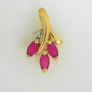 Rubies Estate Pendant 
14 Karat Yellow Rubies Pendant 
Gram Weight 1.05 Chain Style: No Chain 
3 Center Rubies Shape: Marquise With 1 Round Diamond
