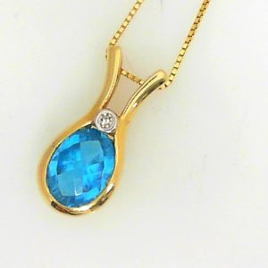 Topaz Estate Pendant 
14 Karat Yellow Blue Topaz Pendant 
 Chain Style: Curb 14 Karat Yellow Length: 18in 
1 Center Topaz 2.75ct Shape: Oval; Colour: Blue With 1 Round Diamond