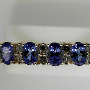 Estate Bracelet With Tanzanites 
14 Karat Yellow Tanzanites Bracelet Width: 7mm 
Gram Weight 20.4 
9 Center Tanzanites Shape: Oval With 20 Round Diamonds 1.00 ctw