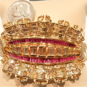 Estate Bracelet With Rubies 
18 Karat Yellow Pink Rubies Bracelet 
Gram Weight 78.8 
56 Center Rubies Shape: Various Shapes; Colour: Pink With 6 Baguette Diamonds 1.50 ctw and 4 Baguette Diamonds 0.80 ctw and 4 Baguette Diamonds 0.36 ctw and 4 Baguette