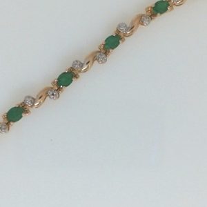 Estate Bracelet With Emeralds 
10 Karat Yellow Emeralds Bracelet Length: 7in Width: 4mm 
Gram Weight 5.3 
11 Center Emeralds Shape: Oval With 24 Single Cut Diamonds 0.005 ctw