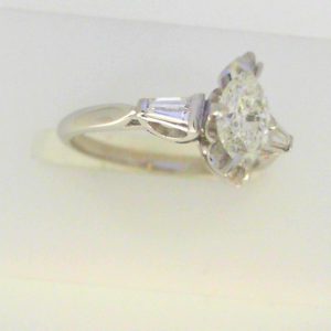 Diamond Engagement Ring 
18 Karat White Engagement Ring 0.68twt
Finger Size 5.75 
1 Center Diamond 0.54ct Shape: Marquise Clarity: VS2 Colour: J With 2 Baguette Diamonds 0.14 ctw 0.68