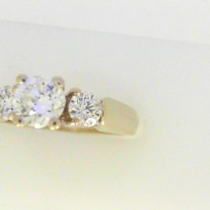 Diamond Engagement Ring 
14 Karat White Engagement Ring 0.9twt
Finger Size 5.25 Gram Weight 4.2gram weight Width: 2.5 
3 Center Diamonds Shape: Round Clarity: SI2 Colour: H 0.9