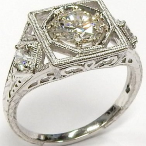Estate Diamond Engagement Ring 
14 Karat White Estate Engagement Ring Width 1.8mm 
Finger Size 6.5 Gram Weight 3.95 
1 Center Diamond 0.90ct Shape: Round; Clarity: SI1; Colour: G With 2 Round Diamonds 0.27 ctw 1.17