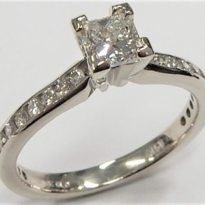 Estate Diamond Engagement Ring 
14 Karat White Estate Engagement Ring Width 2.5mm 
Finger Size 6.25 Gram Weight 2.96 
1 Center Diamond 0.56ct Shape: Princess; Clarity: I1; Colour: H With 22 Round Diamonds 0.19 ctw 0.75