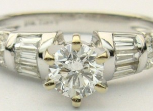 Estate Diamond Engagement Ring 
18 Karat White Estate Engagement Ring 
Finger Size 6.5 Gram Weight 4.4 
 Center Diamond Shape: Round; Clarity: SI2; Colour: F Various Shapes Diamond 0.28 ctw 0.66