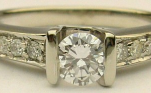 Estate Diamond Engagement Ring 
14 Karat White Estate Engagement Ring Width 2mm 
Finger Size 5.75 Gram Weight 2.8 
1 Center Diamond 0.27ct Shape: Round; Clarity: SI1; Colour: G With 8 Round Diamonds 0.10 ctw 0.37