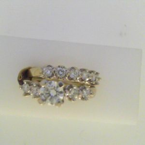 Estate Diamond Engagement Ring 
14 Karat White Estate Engagement Ring Width 5.2mm 
Finger Size 6 Gram Weight 9.4 
 Center Diamond Shape: Round With 1 Round Diamond and 10 Round Diamonds 1.22